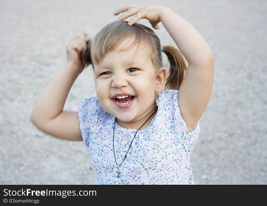 Portrait of blonde little girl outdoors