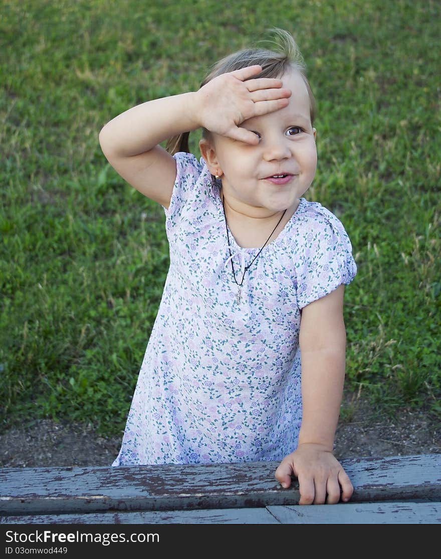 Portrait of blonde little girl outdoors