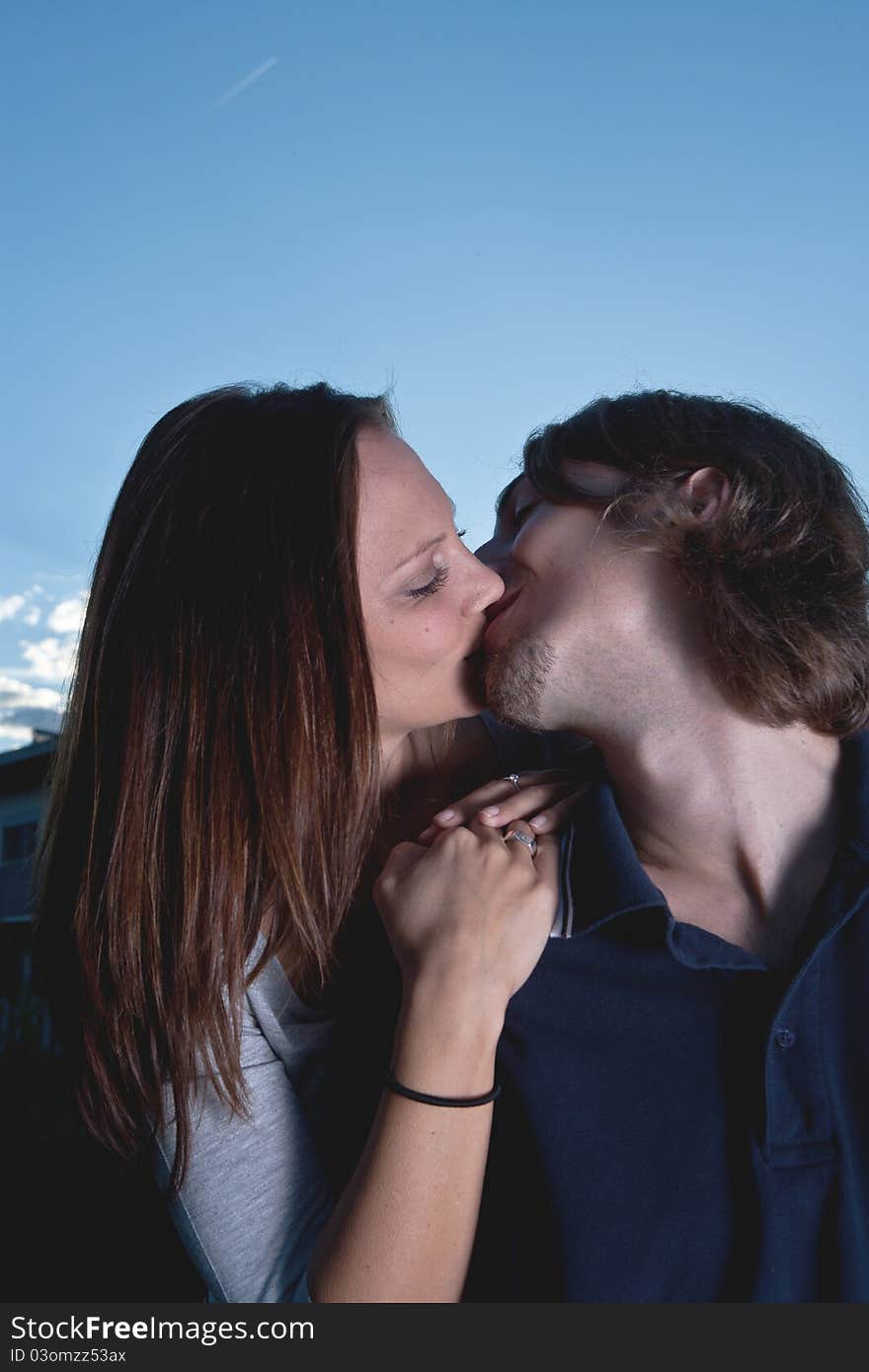 Young couple in love with blue sky in the background. Young couple in love with blue sky in the background