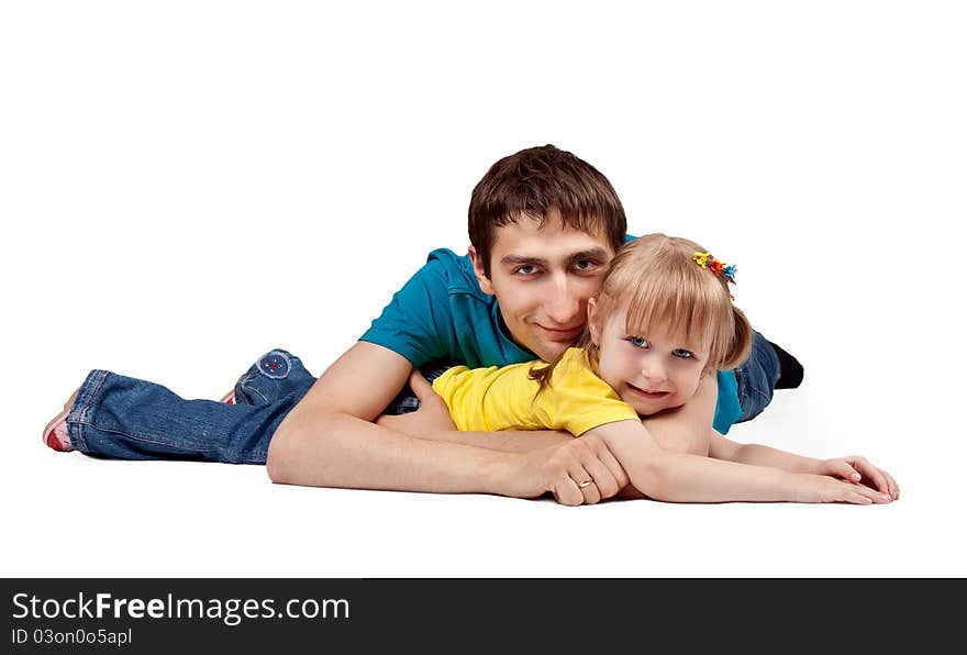 Dad and little daughter lying on the floor in the studio on a white background