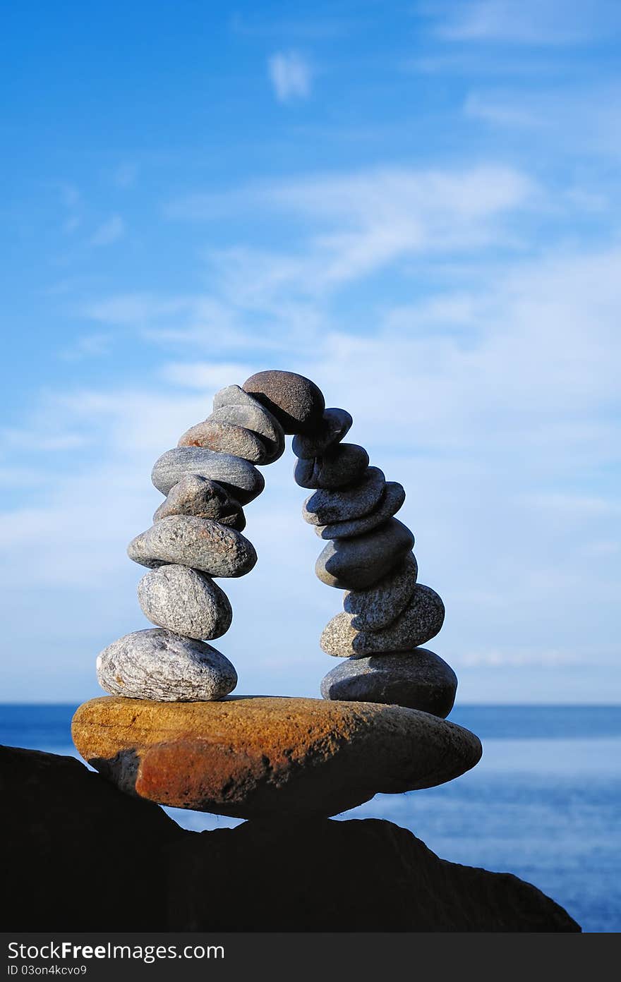 Pebbles curved as arch on the seashore. Pebbles curved as arch on the seashore