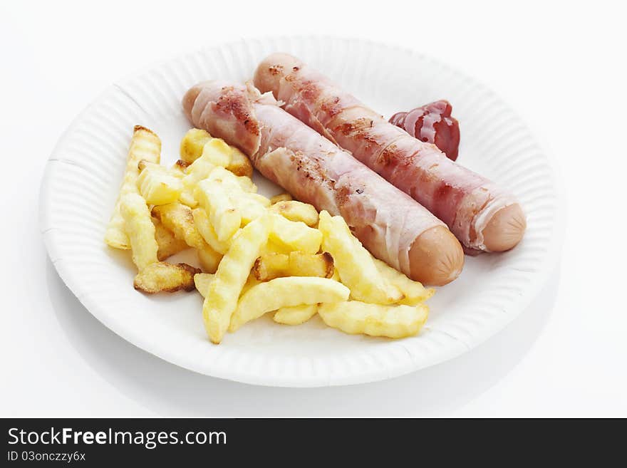 Grilled bernese sausages with french fries and ketchup on a plate on white background