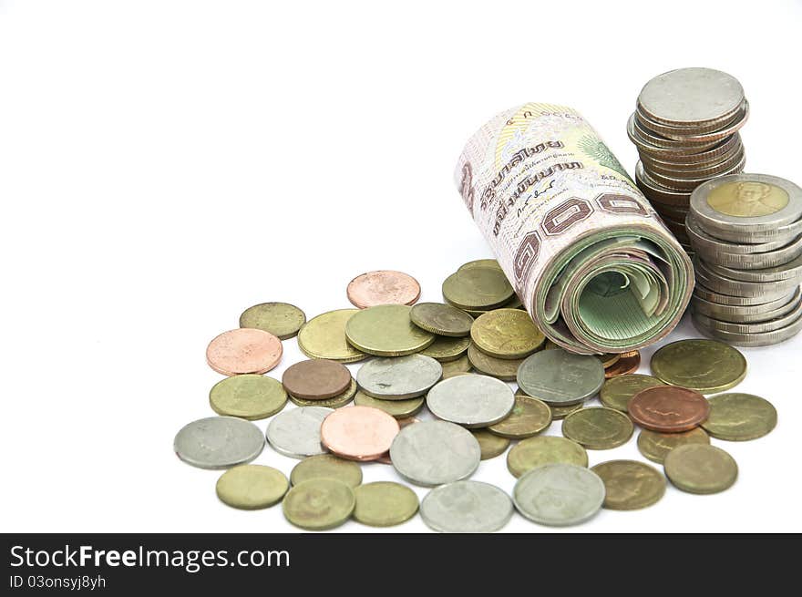 Roll of one thousand baht Thai banknote and coin on white background. Roll of one thousand baht Thai banknote and coin on white background