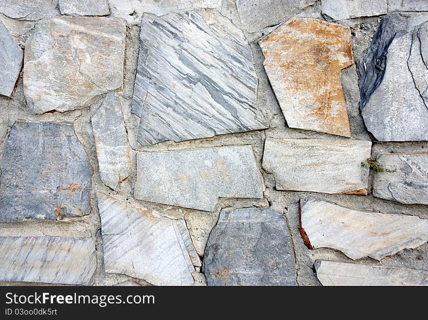 Fund of screen of a wall of gray stones with brown tones in a point of attention.