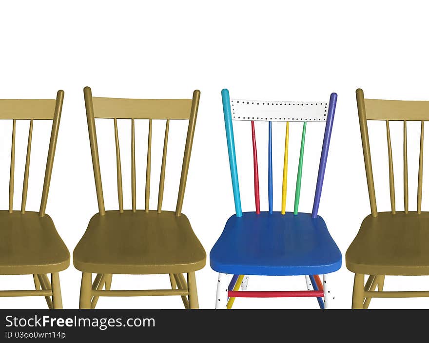 Four chairs, three are toned brown, and one is in a variety of colors. Concept of â€œstand out in a crowdâ€. Isolated on white. Four chairs, three are toned brown, and one is in a variety of colors. Concept of â€œstand out in a crowdâ€. Isolated on white.