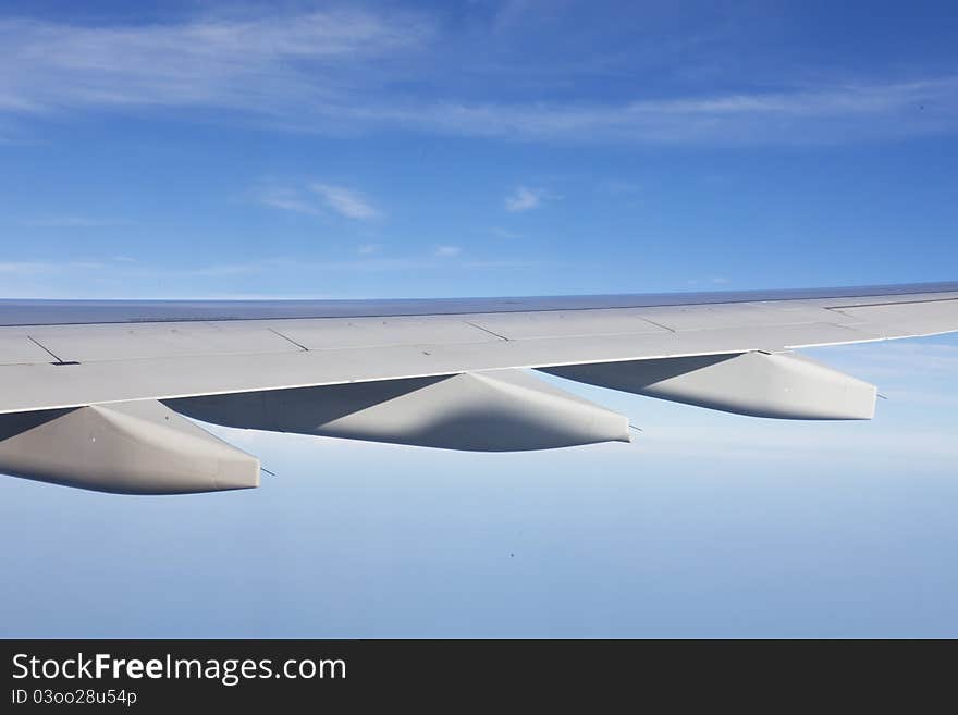 Wing of the plane on a background of sky