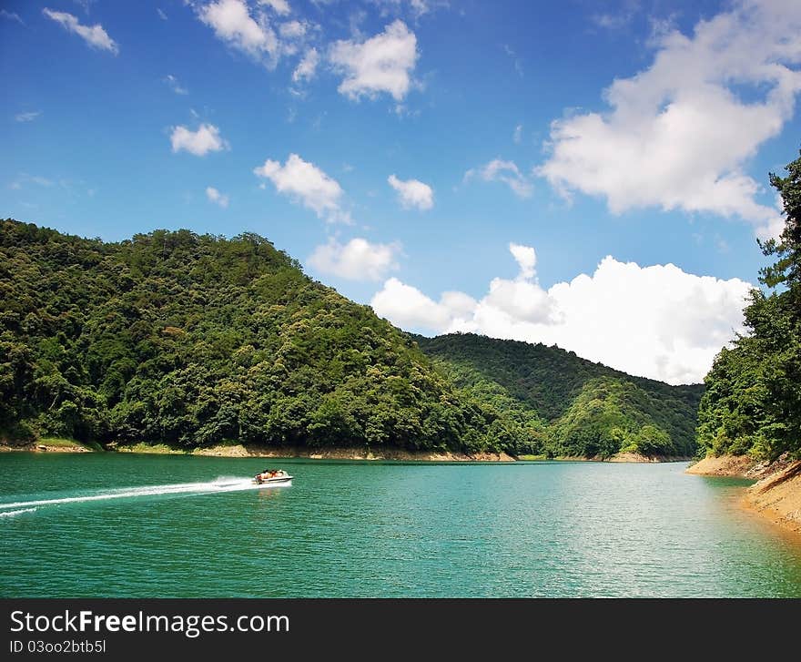 Little boat in the green river with blue sky. Little boat in the green river with blue sky.