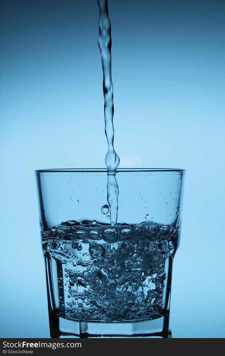 Water being poured into a glass.