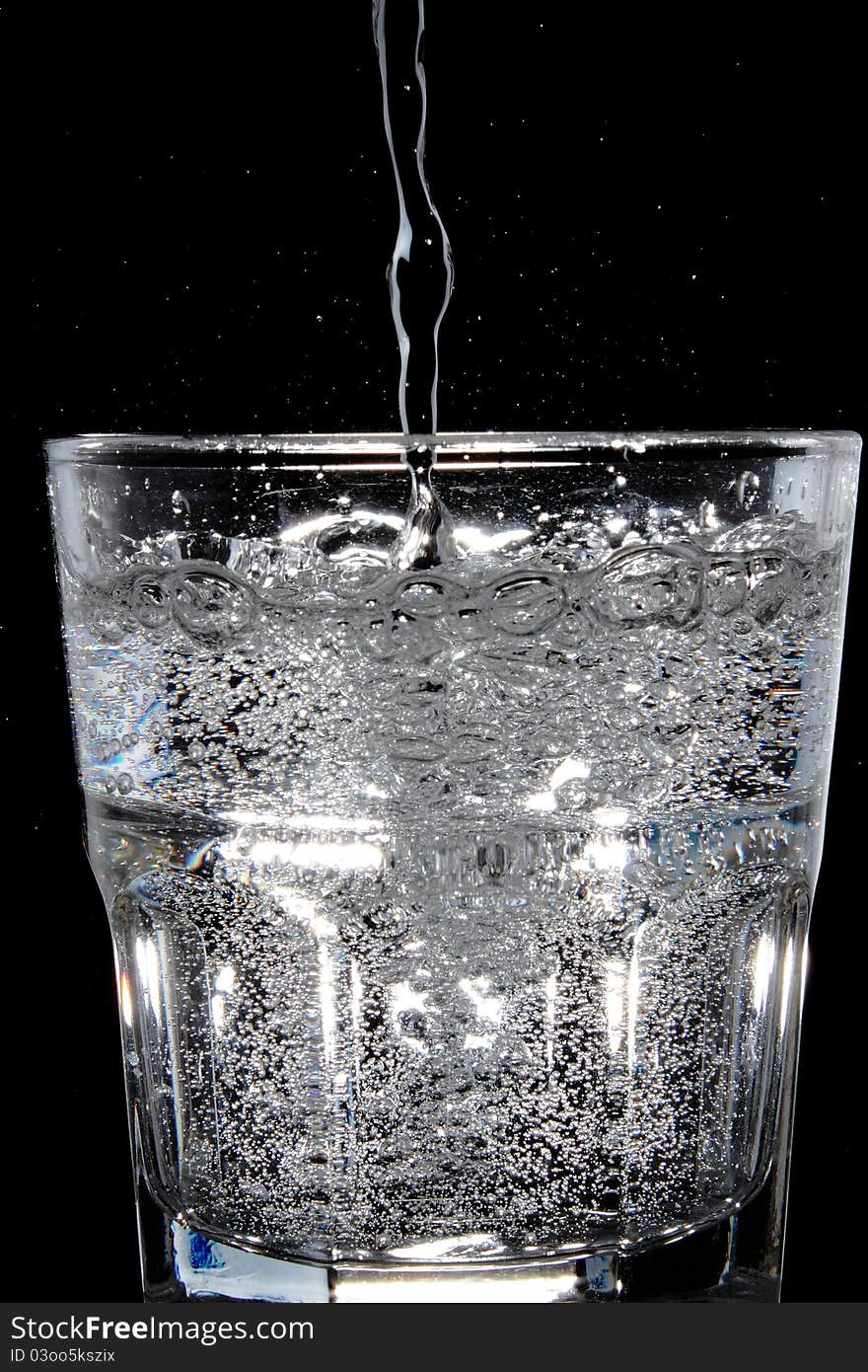 Water being poured into a glass.