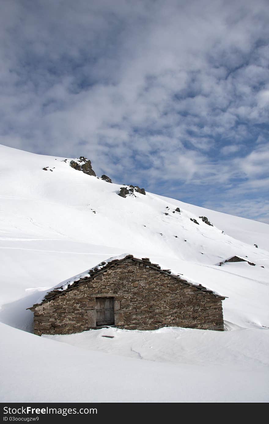 Mountain cabin in the snow in the Alps