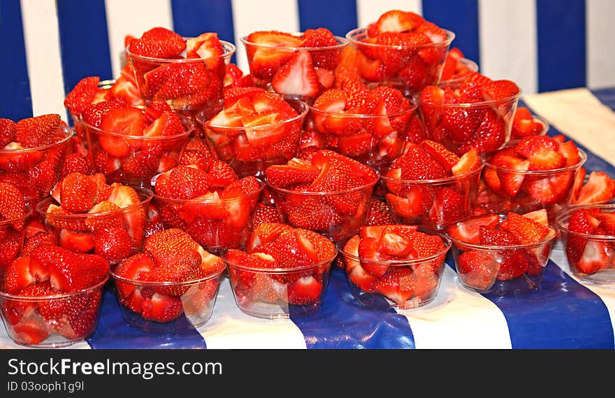 A Display of Strawberries in Small Plastic Bowls. A Display of Strawberries in Small Plastic Bowls.