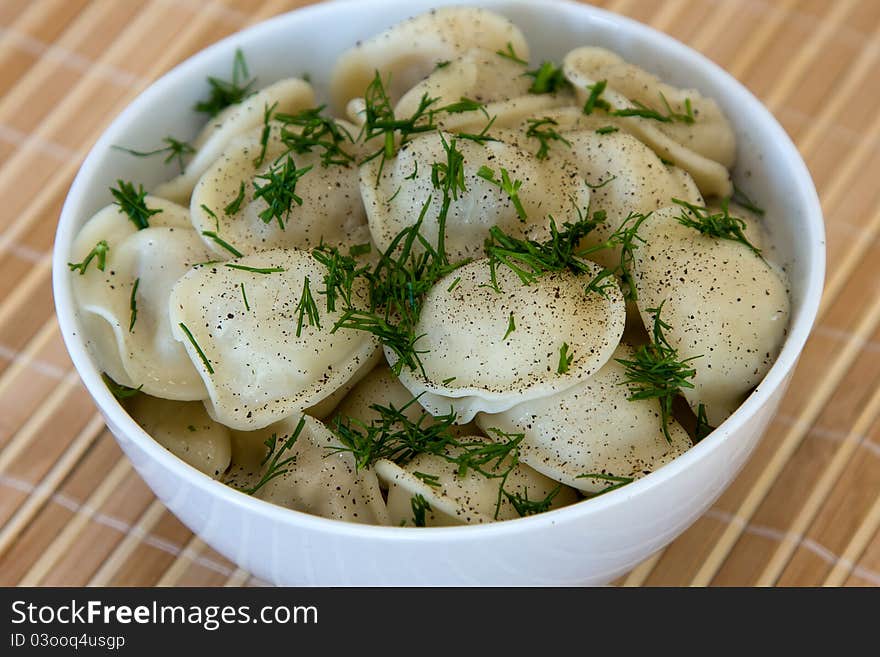 Bowl with traditional russian dish - pelmeni. Bowl with traditional russian dish - pelmeni.