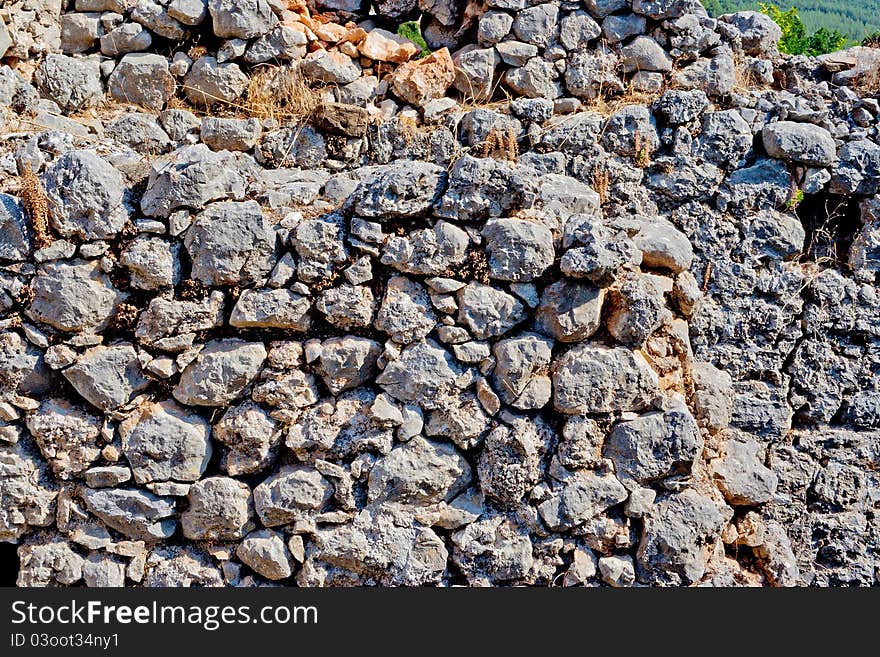 Fragment of wall made of wild stone. Fragment of wall made of wild stone