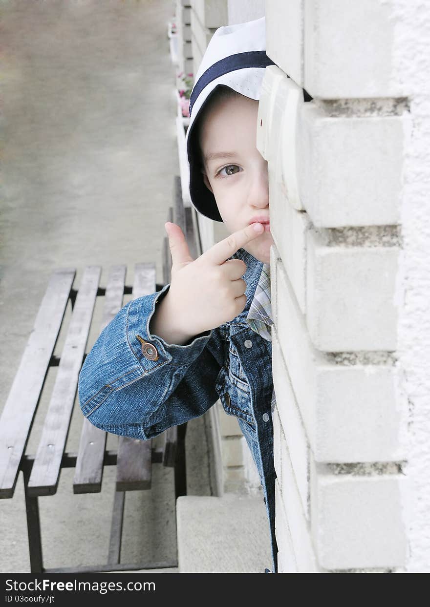 Boy Peeking Around A Wall