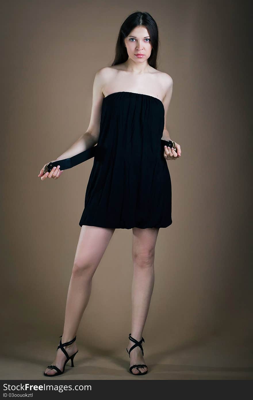 Young woman posing with a girdle posing in studio. Young woman posing with a girdle posing in studio