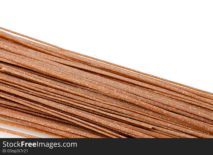 Close up of whole wheat pasta isolated on white background with copy space. Close up of whole wheat pasta isolated on white background with copy space