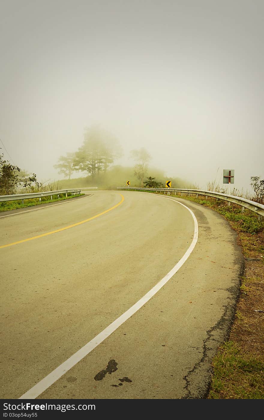 An image of a road covered in fog