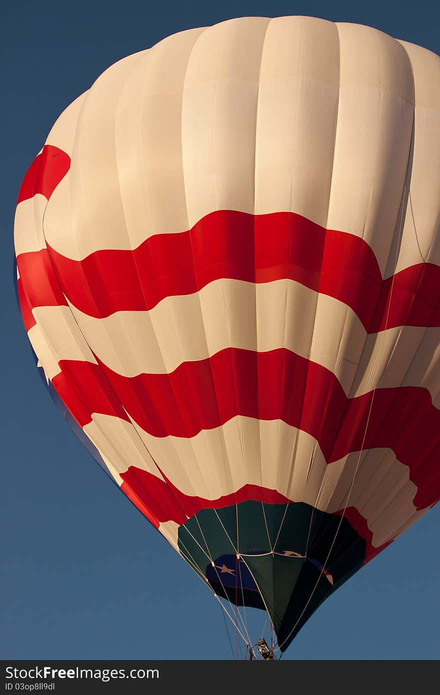 Image of a red, white and blue flag balloon flying. Image of a red, white and blue flag balloon flying