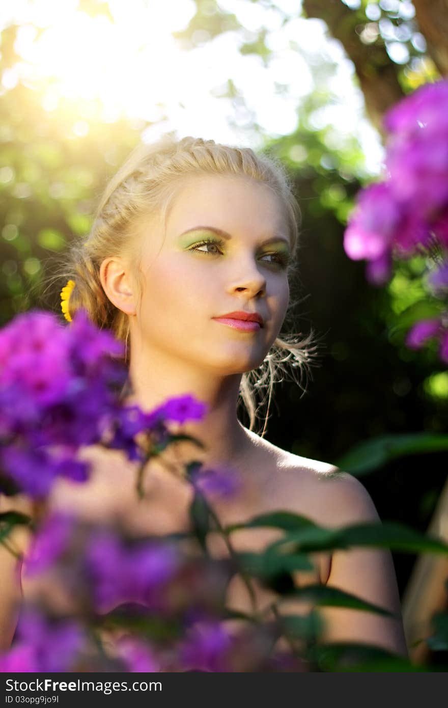 Girl in the garden. Flowers - Purple phlox