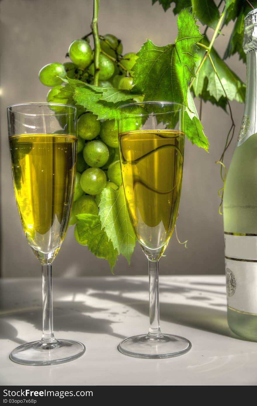 Champagne in glasses, bottle, grapes and grapevine. Champagne in glasses, bottle, grapes and grapevine.