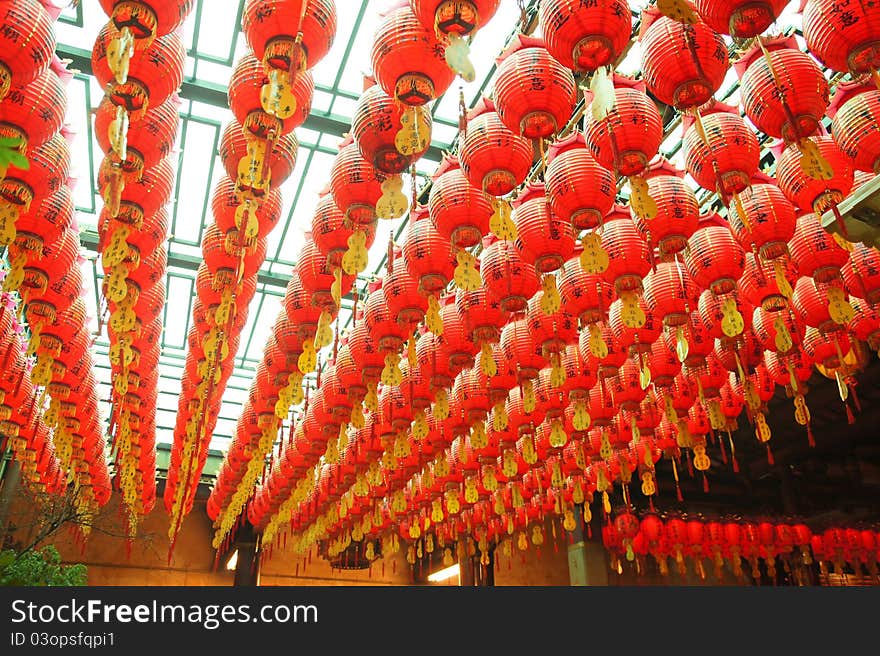 Many red lanterns hang in the temple. They bring good luck and peace to prayer. Many red lanterns hang in the temple. They bring good luck and peace to prayer.