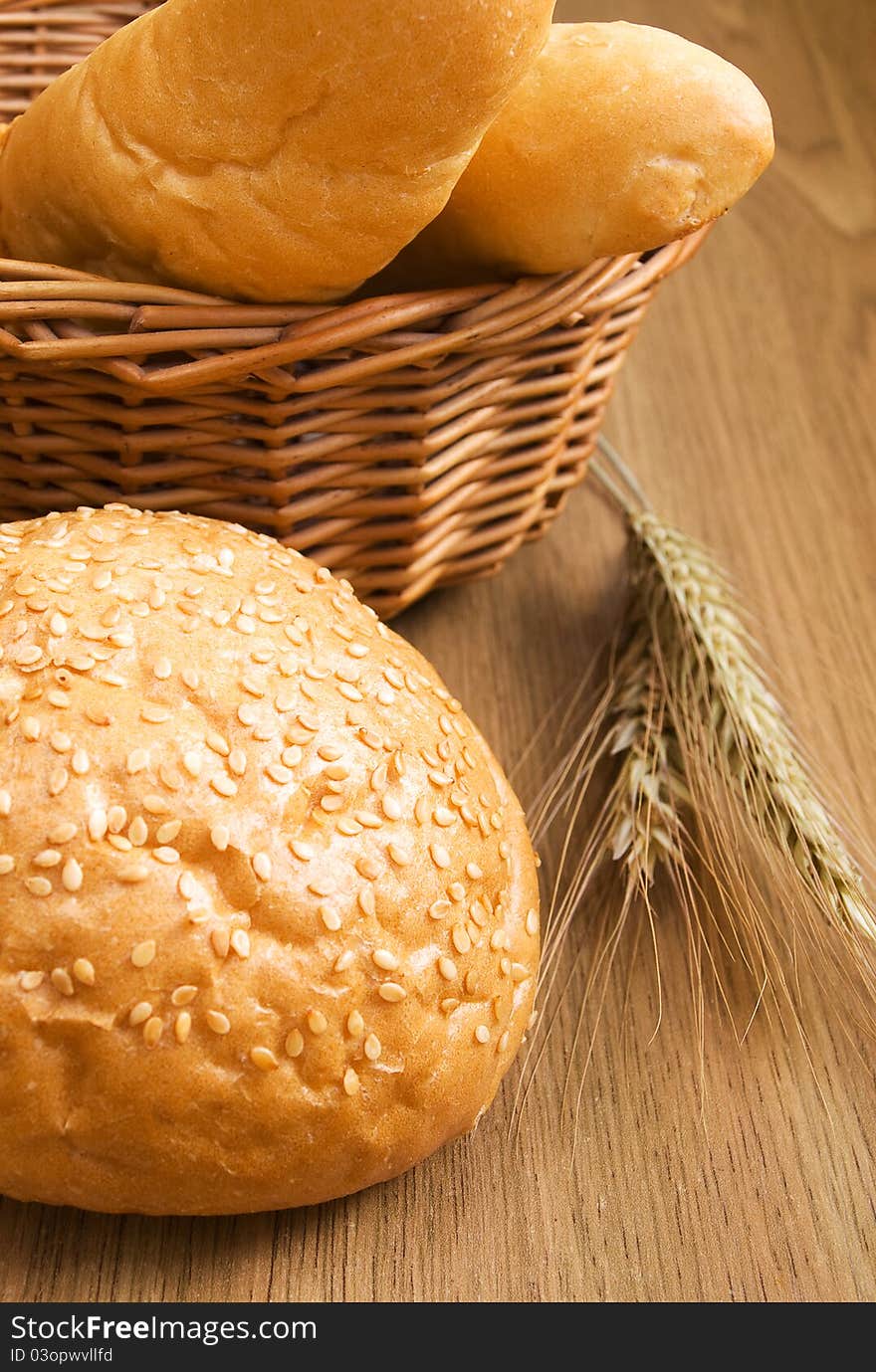 Basket with bread and wheat on the table