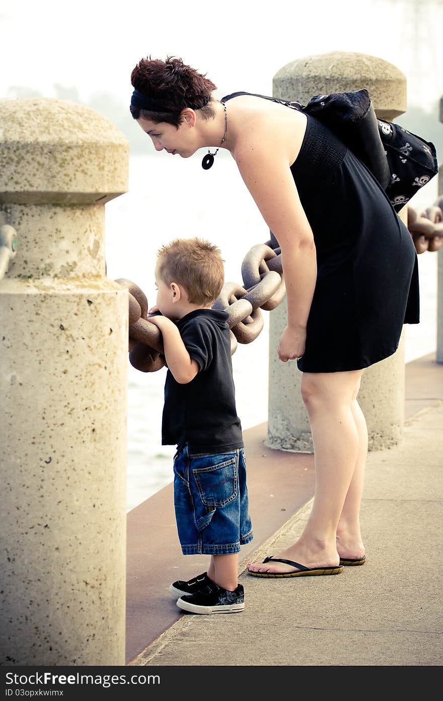 A mother and son spending time together looking at water.