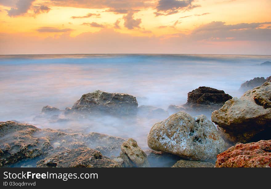 Frozen sea on the background of golden clouds