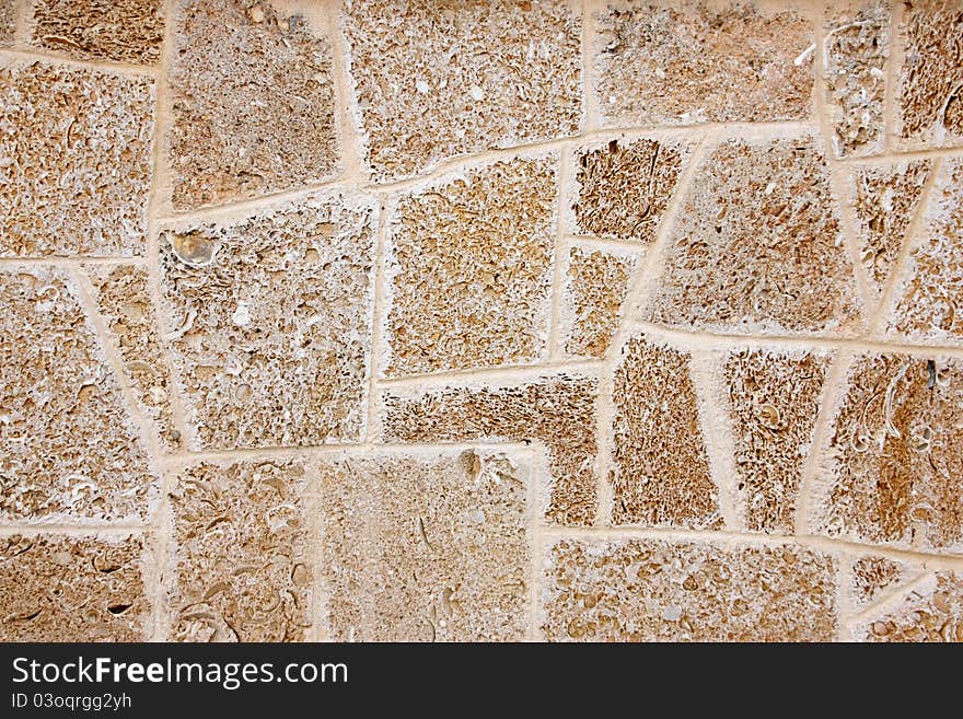 Wall of limestone formed by different geometric forms