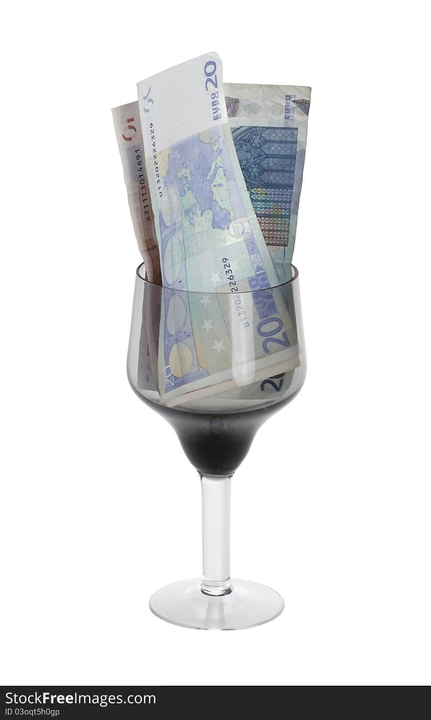 Euro denominations in a glass on a white background. Euro denominations in a glass on a white background.