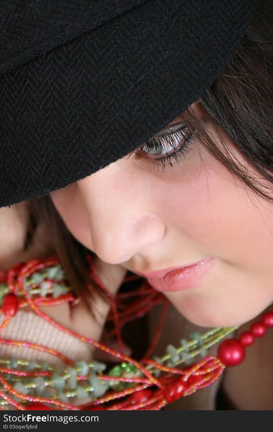 Close-up of a beautiful brunette teen wearing a hat. Close-up of a beautiful brunette teen wearing a hat