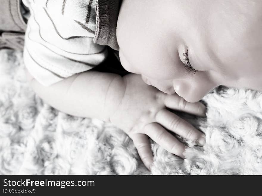 Beautiful newborn baby boy sleeping on a soft blanket. Beautiful newborn baby boy sleeping on a soft blanket