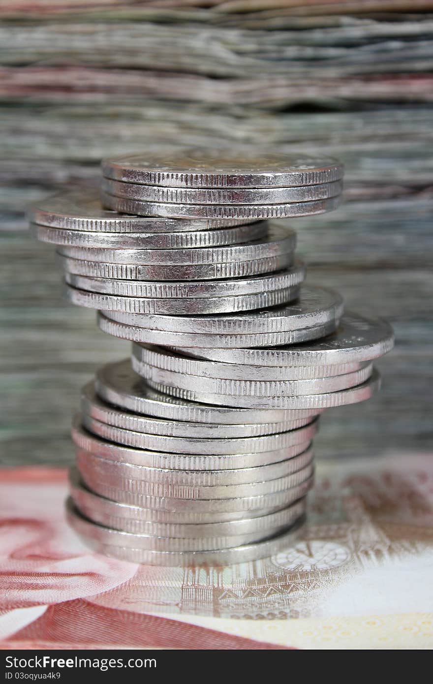 Stack of Canadian dollar bills with coins in front. Stack of Canadian dollar bills with coins in front