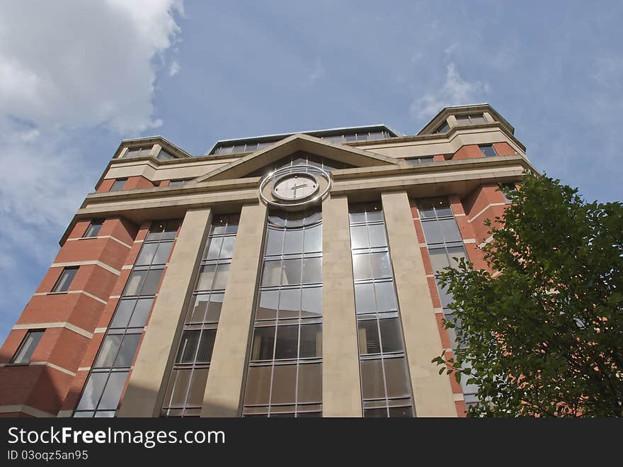 A Red Brick and Glass Office Block with Modern Clock