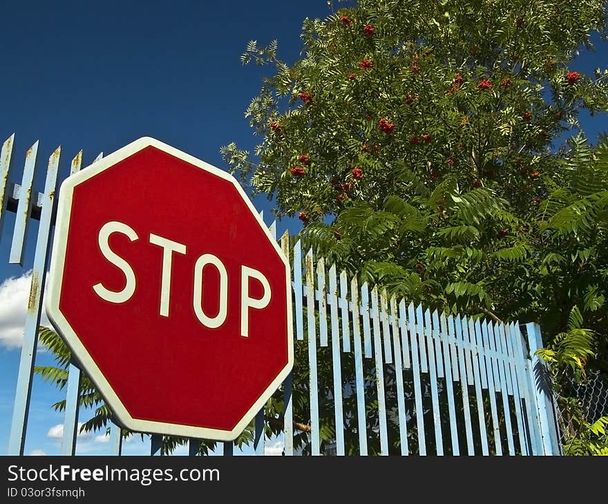 Stop sign on the old gate