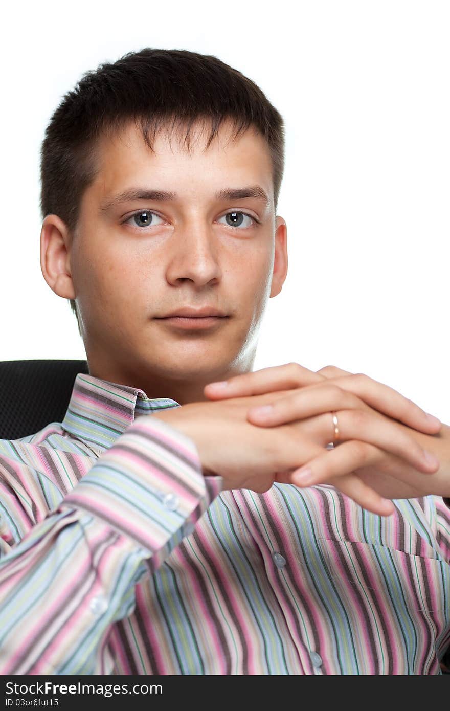 Portrait of a young thinking businessman on white background sitting in a chair