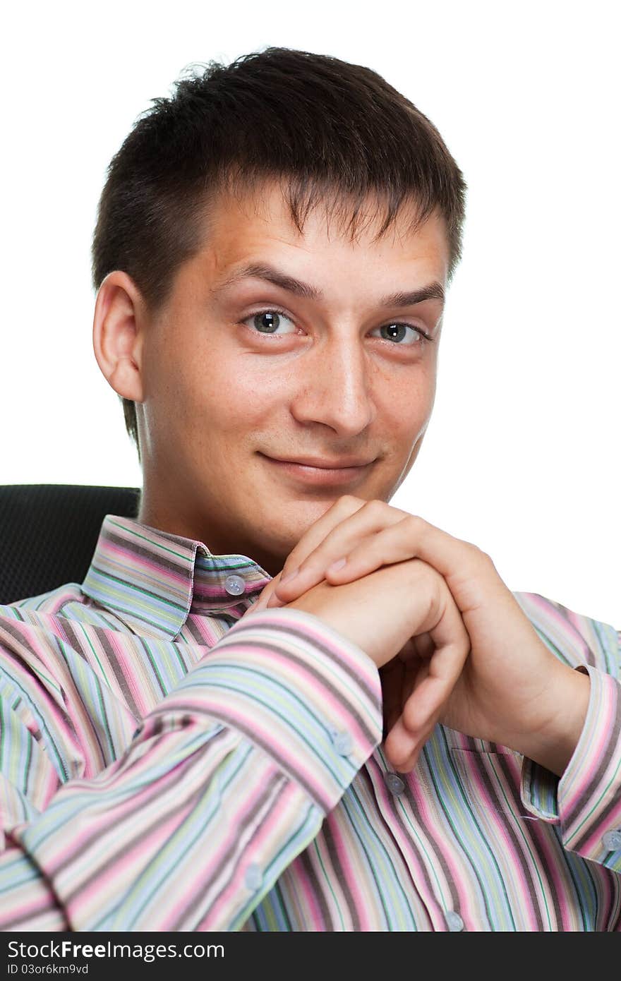 Portrait of a smiling young businessman on white background sitting in a chair