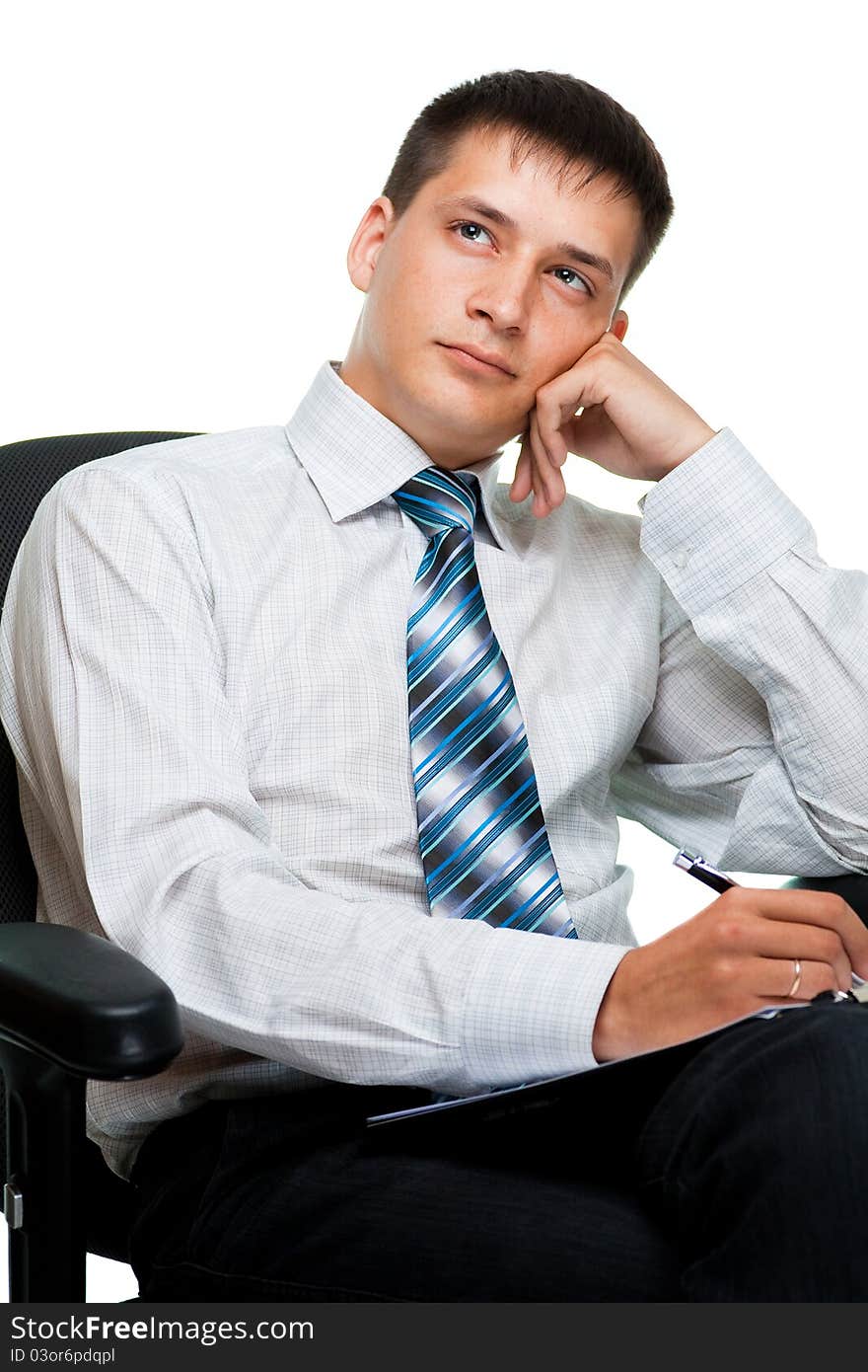 Portrait of adreaming young businessman, isolated on a white background sitting on a chair. Portrait of adreaming young businessman, isolated on a white background sitting on a chair