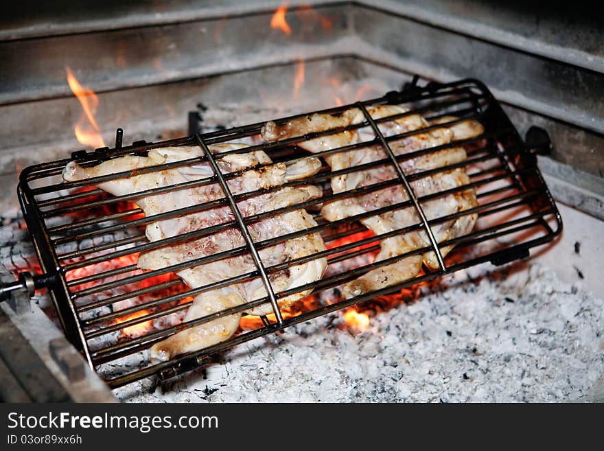 Grilled chicken getting ready on charcoal fire