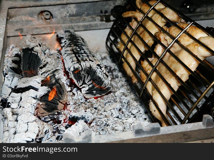 Grilled chicken getting ready on charcoal fire