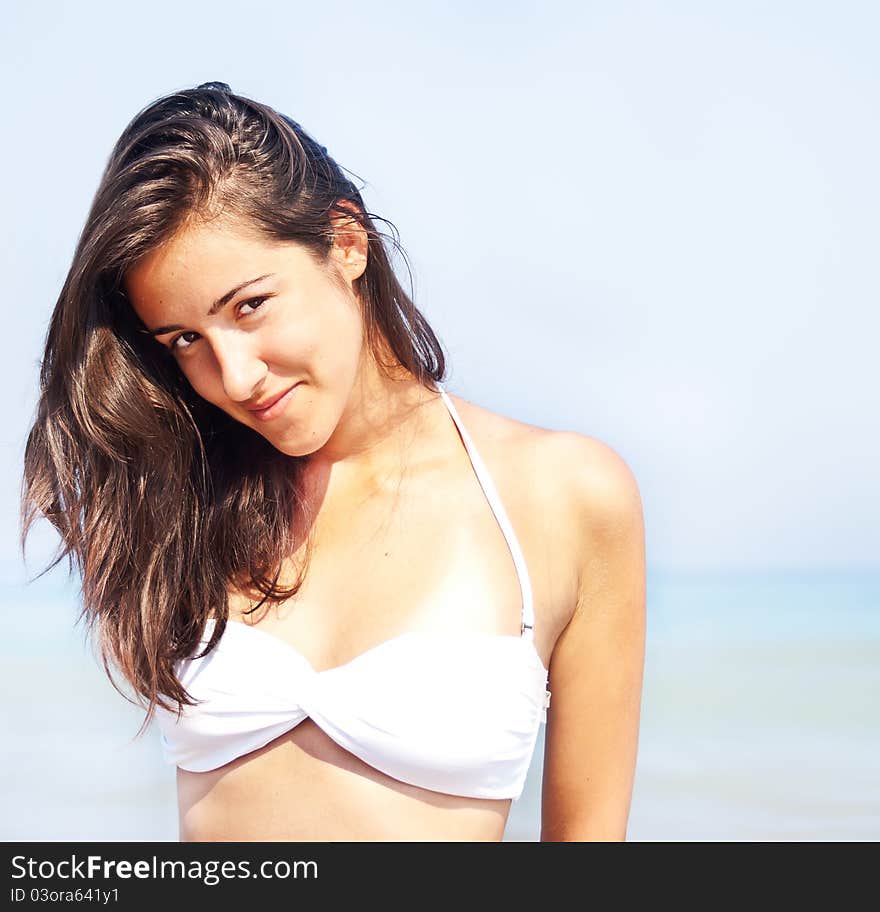 Young woman smiling and sunbathing at beach. Young woman smiling and sunbathing at beach