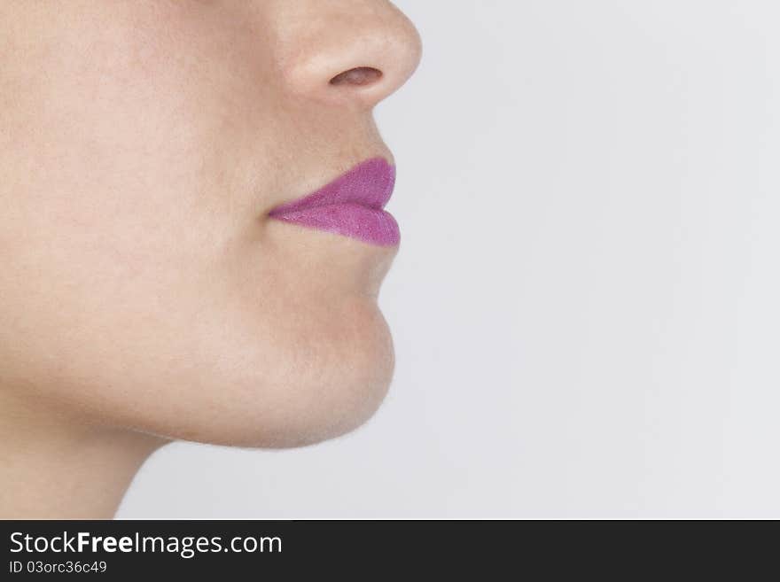 Young woman face in a white background