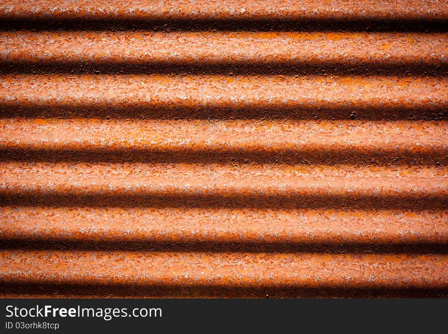 A rusty corrugated iron metal texture.It's a roof.