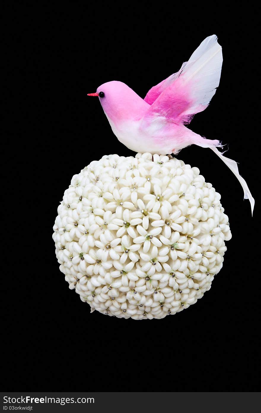 Flower ball and paper bird isolated on black background