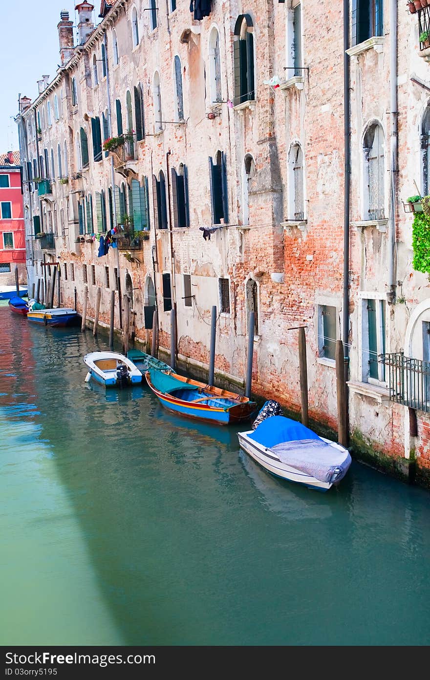 Parked boats on canal in Venice, Italy