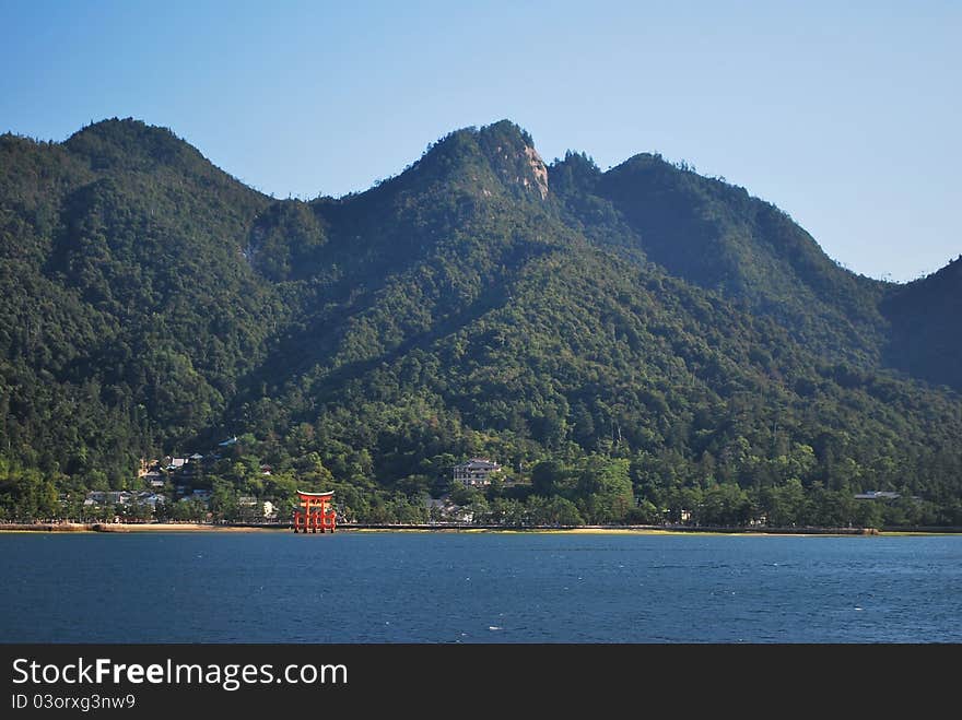 View of red torii gate on Miyajima island located in Hiroshima, Japan. View of red torii gate on Miyajima island located in Hiroshima, Japan.