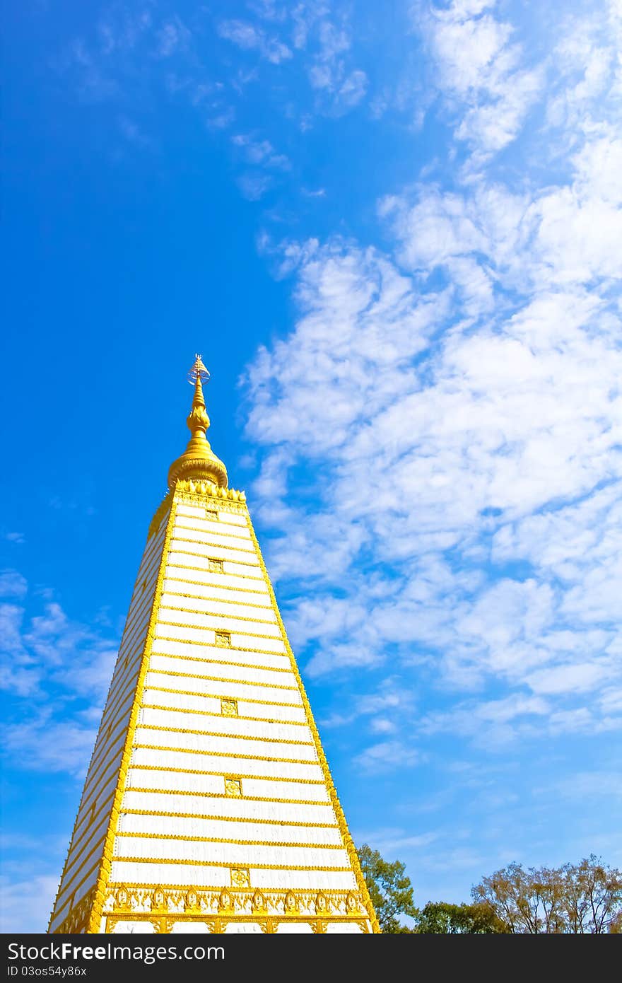 Thai white pagoda in the obligue view with blue sky and white cloud. Thai white pagoda in the obligue view with blue sky and white cloud