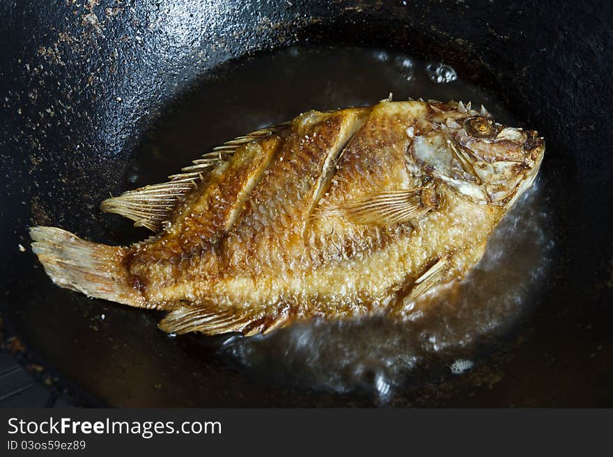 Food cooking, fresh fish in hot oil. Food cooking, fresh fish in hot oil