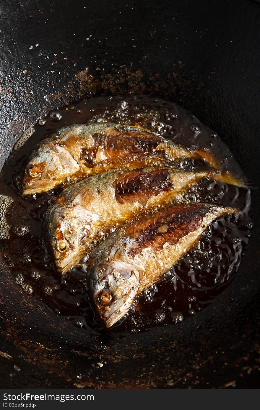 Food cooking, fresh fish in hot oil. Food cooking, fresh fish in hot oil