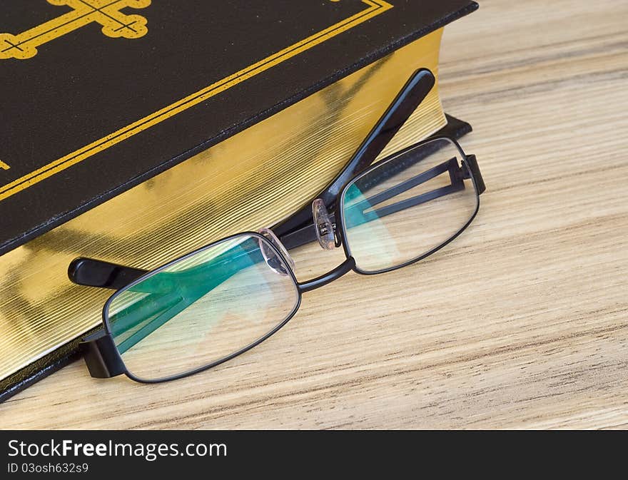 Glasses against the religious book